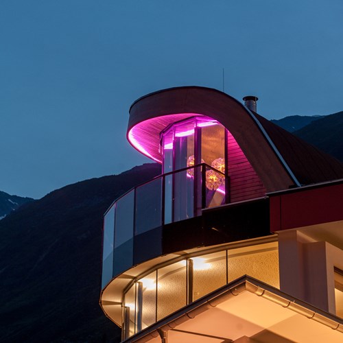 Sky Sphere lit up at night at the top of the Hotel Josl