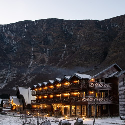 snow covered Flamsbrygga Hotel in Flam, Norway and cliffs