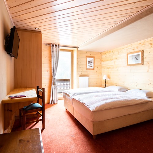 pine clad twin room at Hotel Suisse Champery