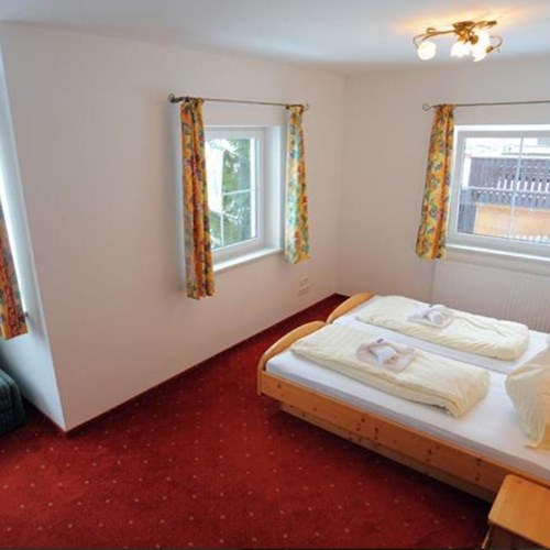 twin room with seating at chalet fauner, catered ski chalet in st anton