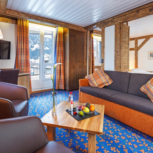 seating area of a junior suite at Hotel Derby in Grindelwald