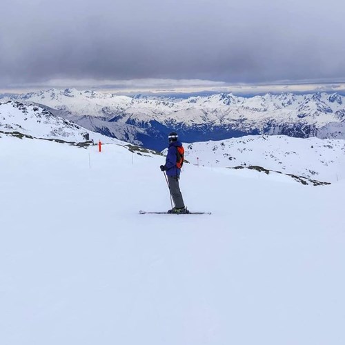 skier on the slopes from behind mountain view
