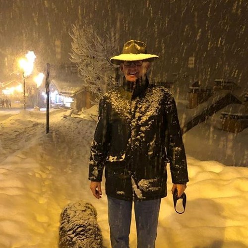 man in meribel in snow with dog