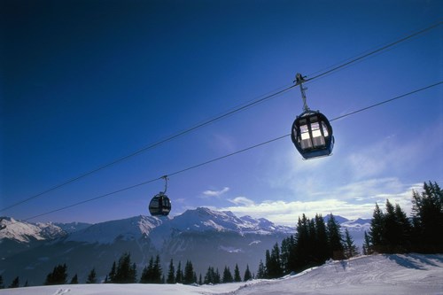 Skiing in Klosters village, gondola in blue skies
