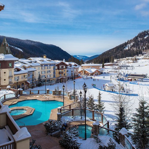 Outdoor pool amongst mountains, Sun Peaks Grand ski accommodation in Canada