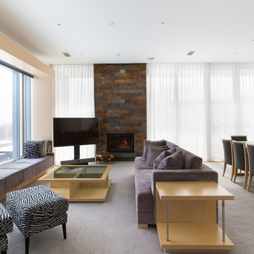 Ski Hotel Chalet Ivy-Niseko-Ski Japan-lounge and dining area with fireplace
