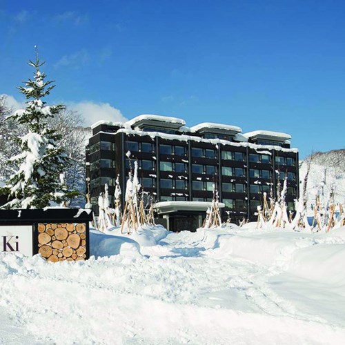 Ski Hotel Ki Niseko - Ski Japan - exterior in snow with blue skies