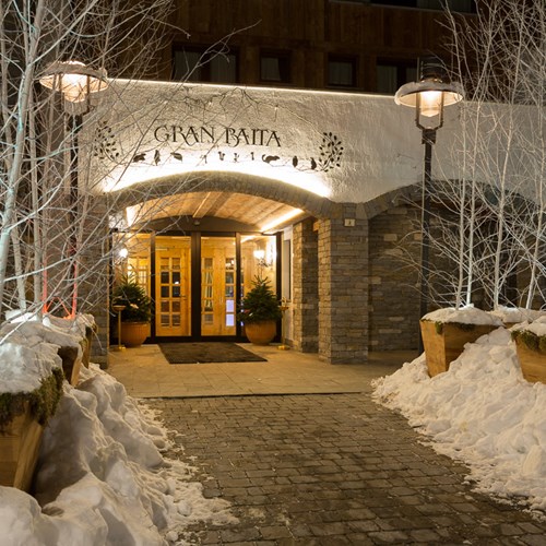 Hotel Gran Baita Courmayeur snow flanked front door