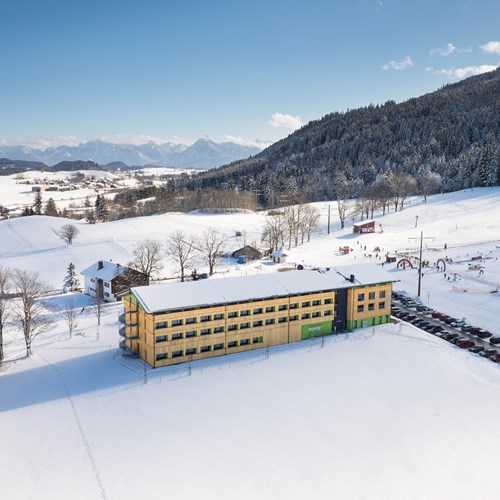Snowy exterior of ski accommodation, Explorer Hotel in St Johann, Austria
