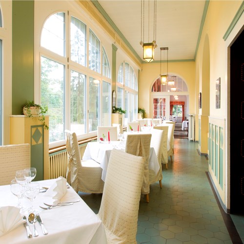 eating area with huge windows at Hotel Belvedere Wengen, Switzerland