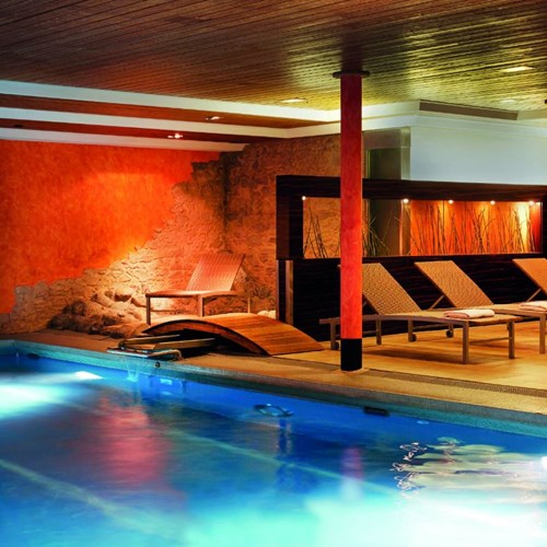 Indoor swimming pool at H+ Hotel and spa in Engelberg